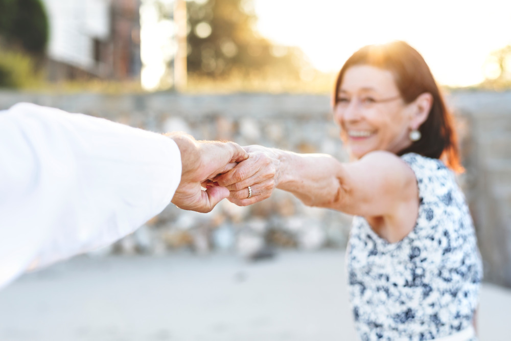 Older woman reaching out and holding another hand