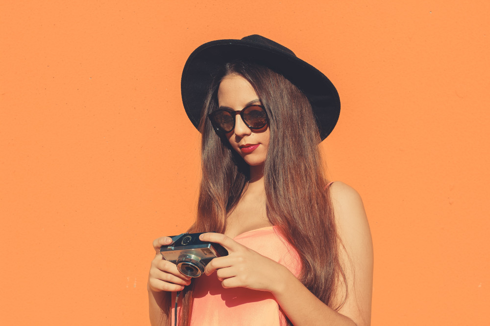 Woman looking down at her camera.
