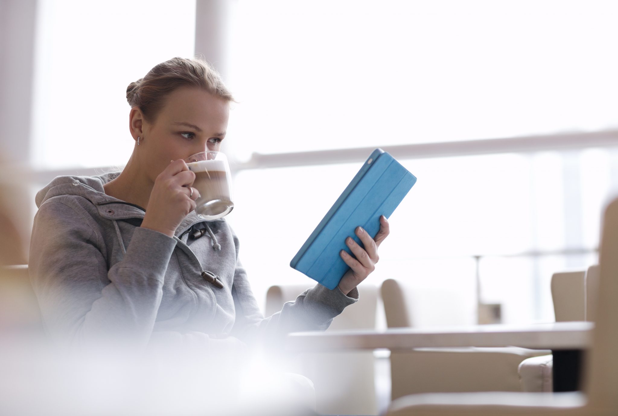 woman using tablet in cafe