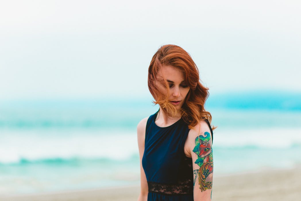 woman with tattoo on beach